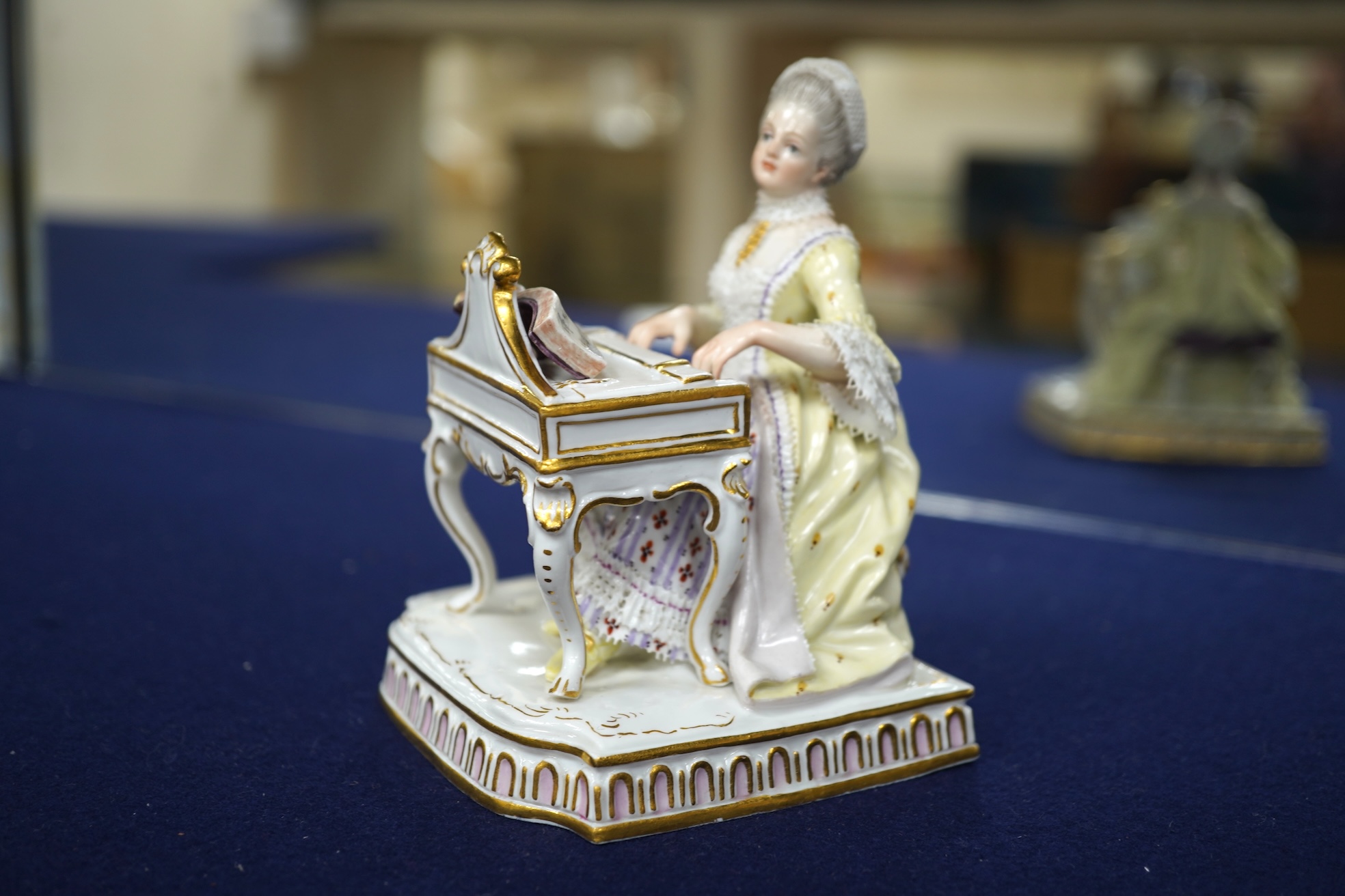A pair of 19th century Meissen figures of a girl holding a shell and a boy holding a book, in size model number 628, tallest 13cm